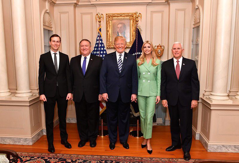 President Trump with advisers, Secretary of State, and Vice President.
