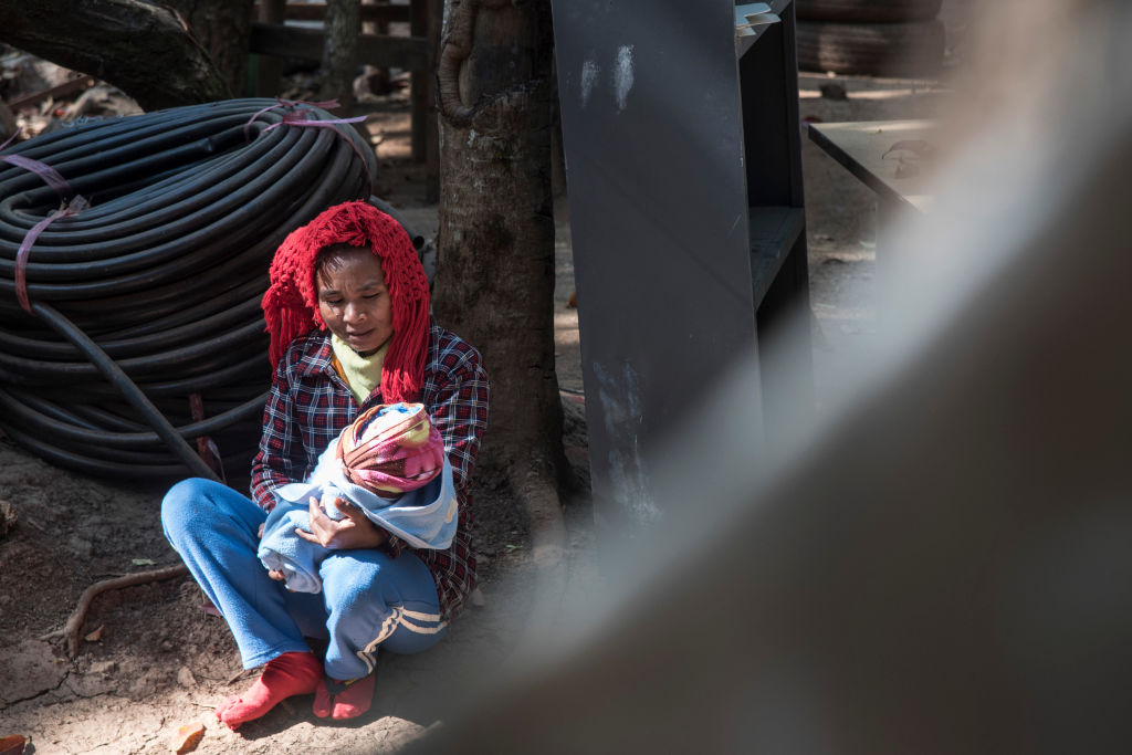 A woman attends her new born baby in February this year after delivering at a secret hospital opened in May 2022 and hidden in the jungle of Kayah State (Thierry Falise via Getty Images)
