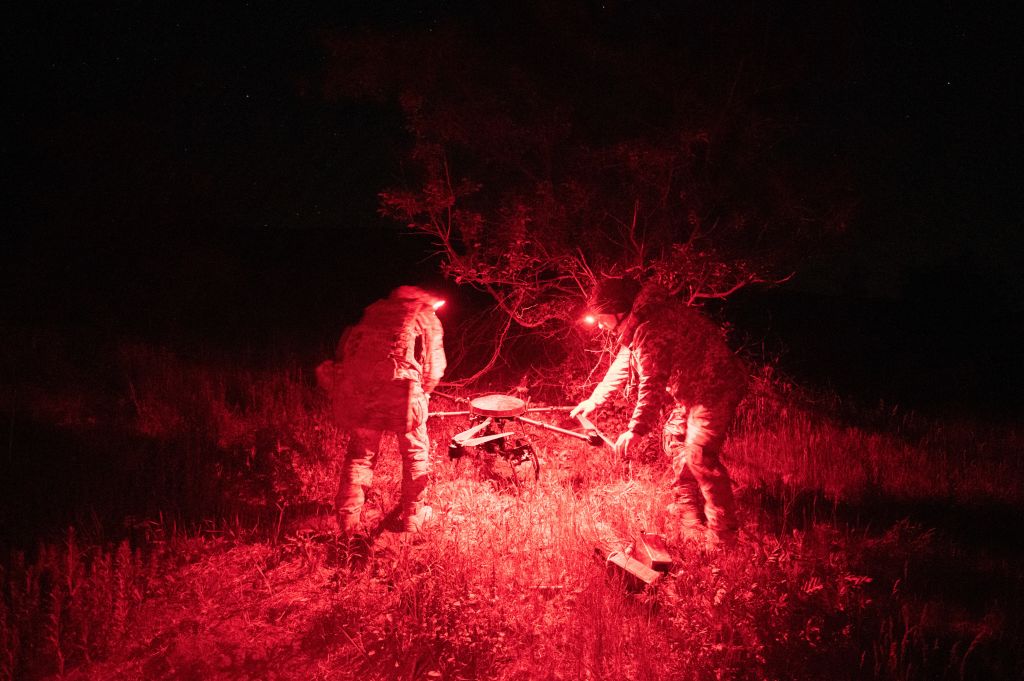 Ukrainian soldiers check a Vampire hexacopter drone after mission flight over a frontline near Chasiv Yar, Donetsk region, on 1 May 2024 (Genya Savilov/AFP via Getty Images)