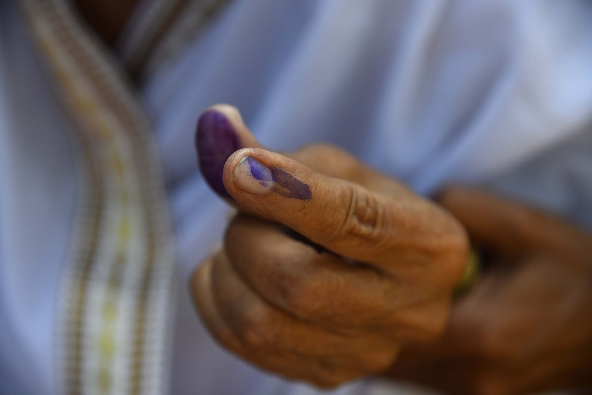 TOPSHOT - An Indian woman shows her ink-marked finger after casting her vote during India's general election in Purandudam village, some 140 km from Guwahati, the capital city of Indias northeastern state of Assam on April 11, 2019. - India's mammoth six-week general election kicked off April 11, with polling stations in the country's northeast among the first to open. (Photo by Biju BORO / AFP) (Photo credit should read BIJU BORO/AFP via Getty Images)