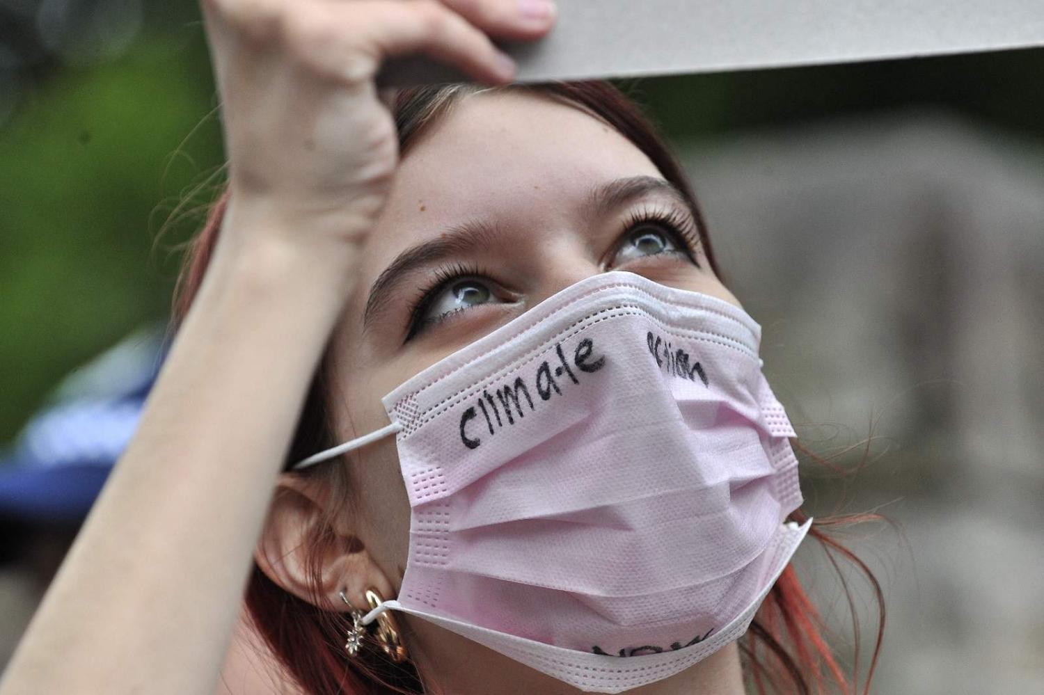A student marches towards the prime minister’s house in Sydney on 25 March 2022 during a climate change protest (Muhammad Farooq/AFP via Getty Images)