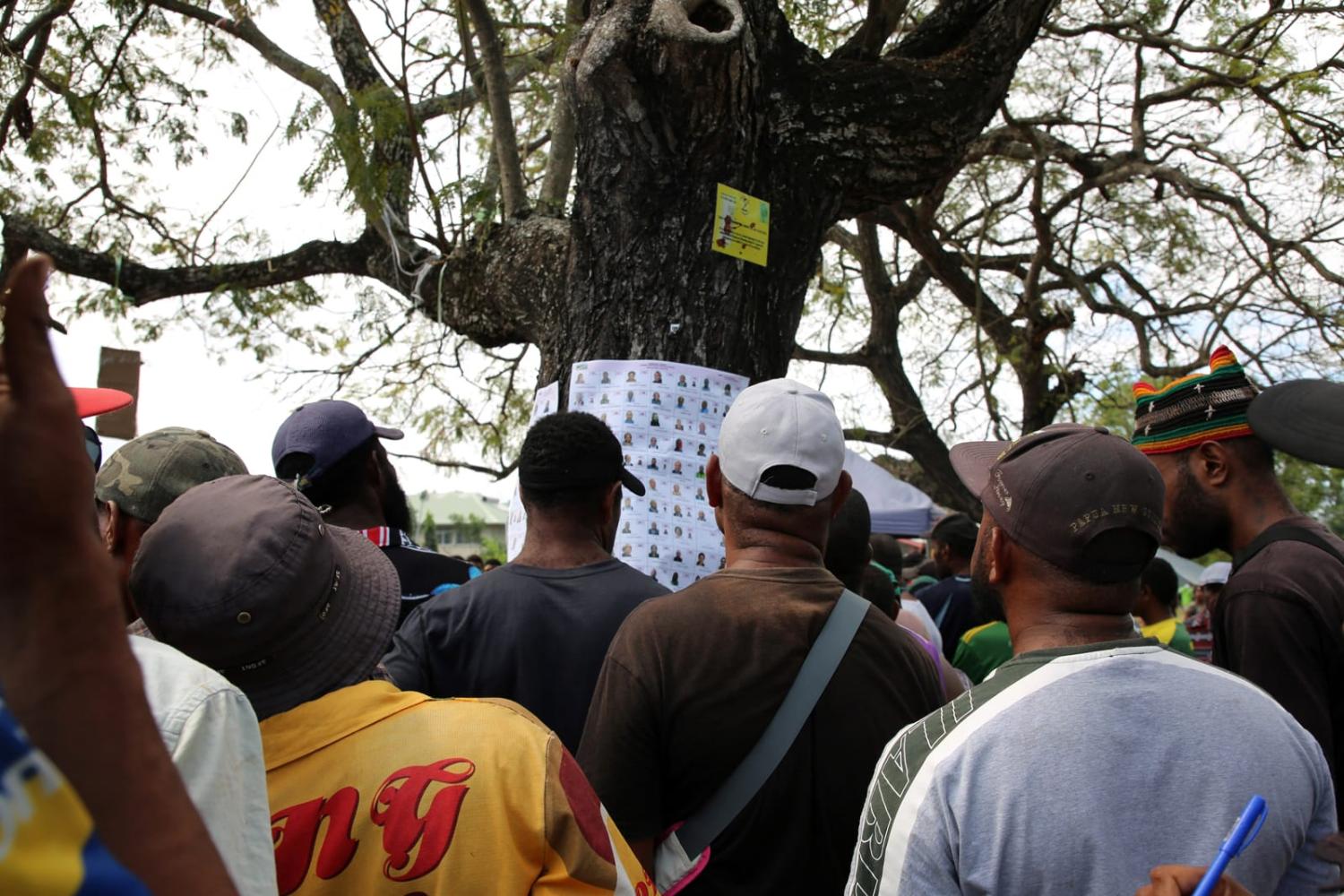 Checking a list of candidates at a polling station in the general elections in the Papua New Guinea capital Port Moresby (Andrew Kutan/AFP via Getty Images)