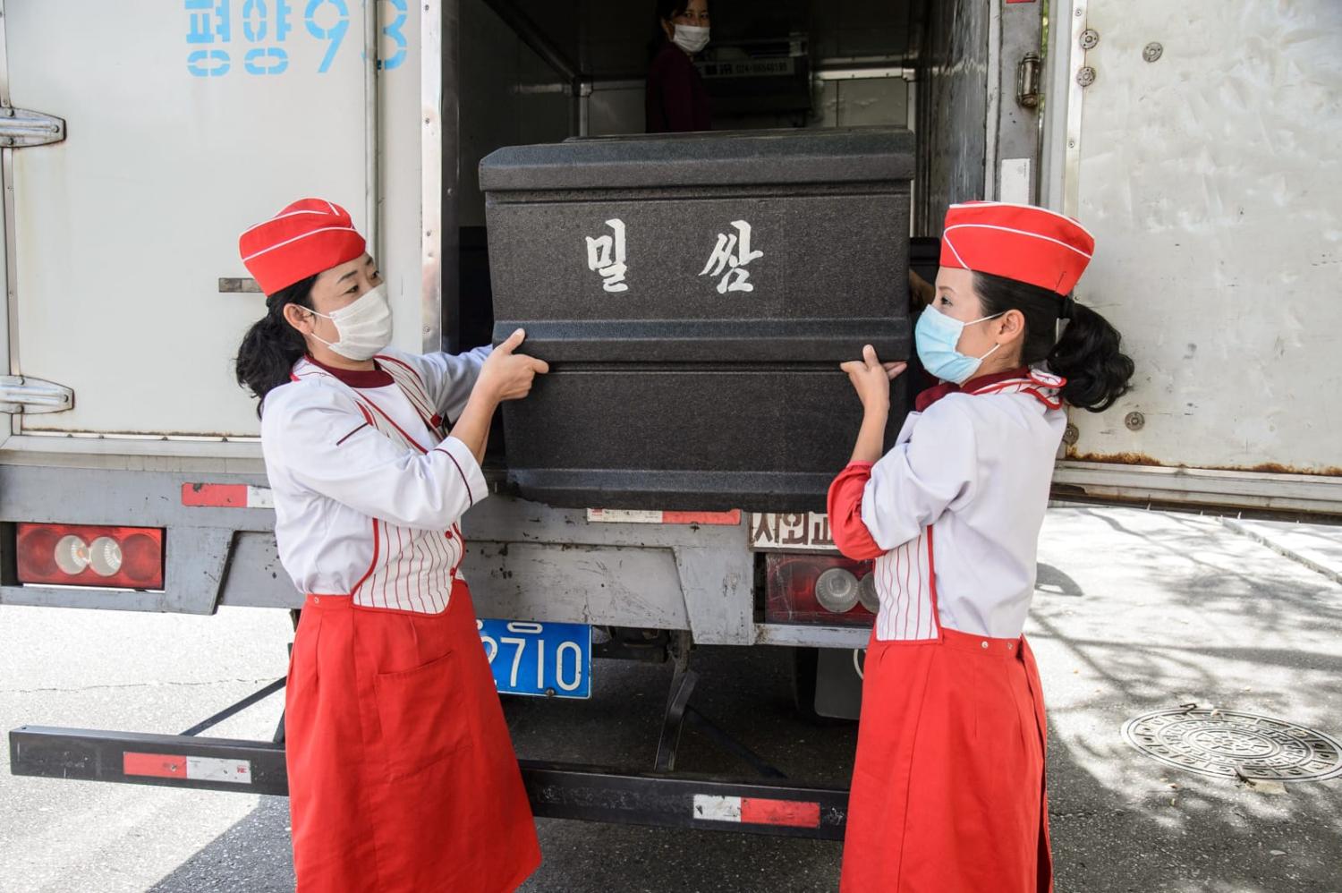A box of wheat cakes stuffed with meat produced by the Kumsong Foodstuff Factory, being carried to a movable vendor stall in the Central district in Pyongyang in September 2021 (Kim Won-jin/AFP via Getty Images)