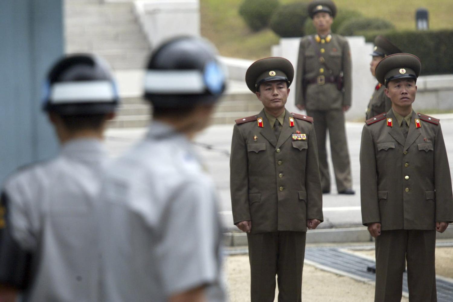 North and South Korean soldiers stand guard at the truce village of Panmunjom in the demilitarised zone separating the two Koreas (Seung-il Ryu/NurPhoto via Getty Images)