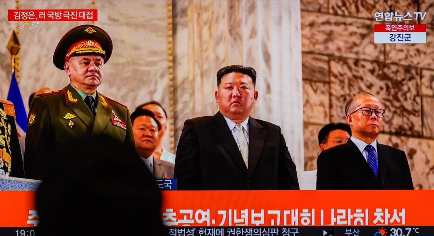 North Korean leader Kim Jong-un, centre, with Russian Defence Minister Sergei Shoigu, left, and Chinese Communist Party politburo member Li Hongzhong during the broadcast of a military parade to mark the 70th anniversary of the signing of the armistice th
