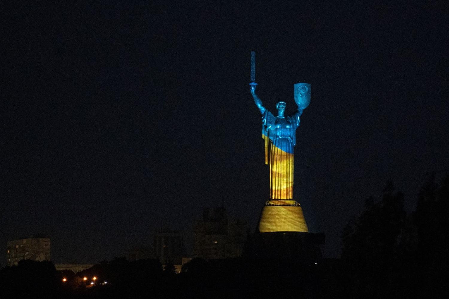 The Motherland monument illuminated in the colours of the Ukrainian flag at the Second World War open-air museum in Kyiv, 4 July 2023 (Genya Savilov/AFP via Getty Images)