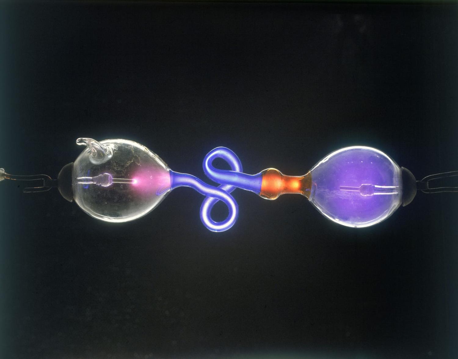 A Geissler tube: Two metal electrodes pass through the glass tubes, which contain rarified gases at low pressure (SSPL/Getty Images)