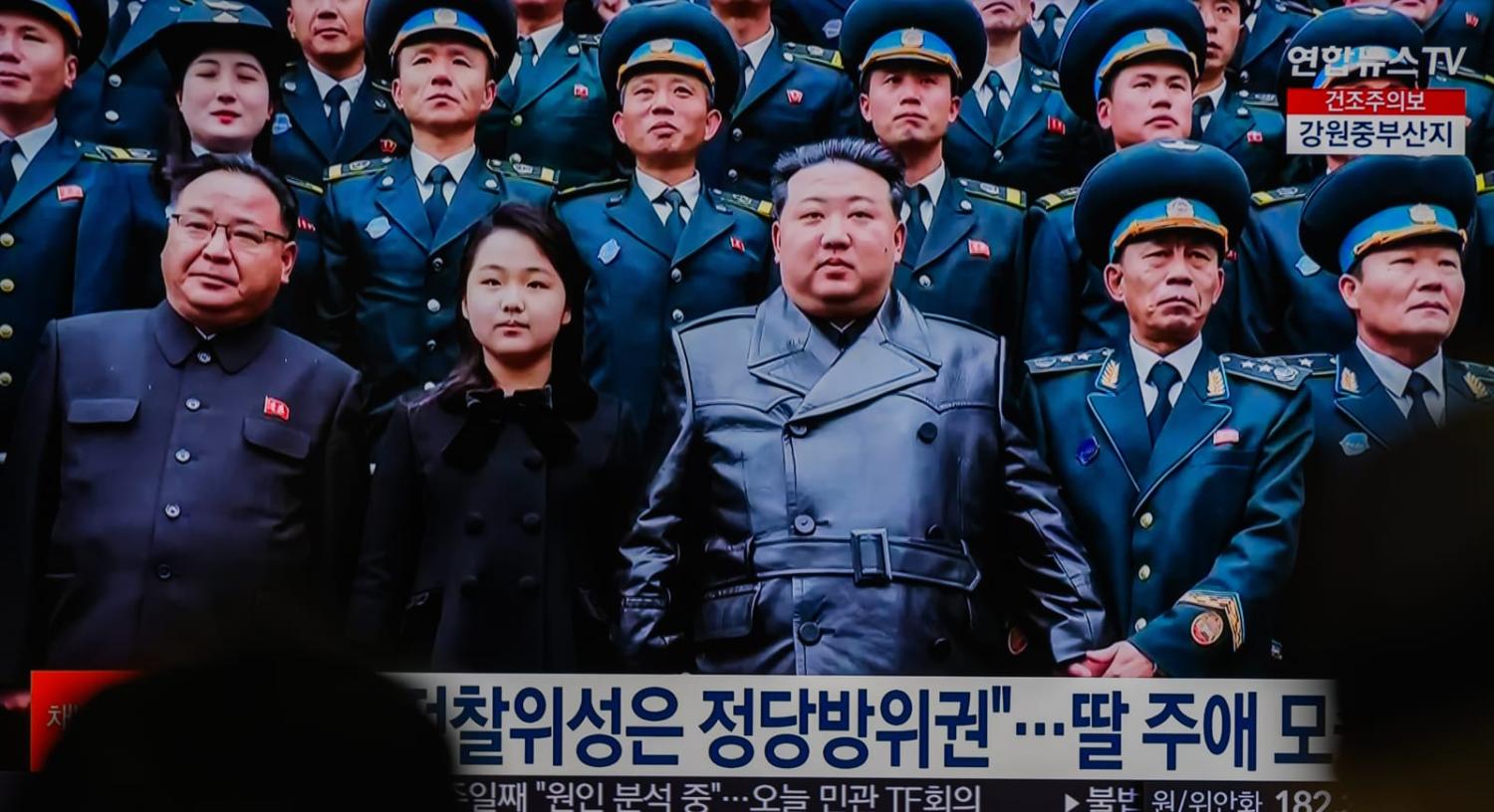 Footage of Kim Jong-un alongside his daughter, believed to be named Kim Ju-ae, posing for a photo with scientists and engineers who contributed to the country's latest launch of a reconnaissance satellite (Kim Jae-Hwan via Getty Images)