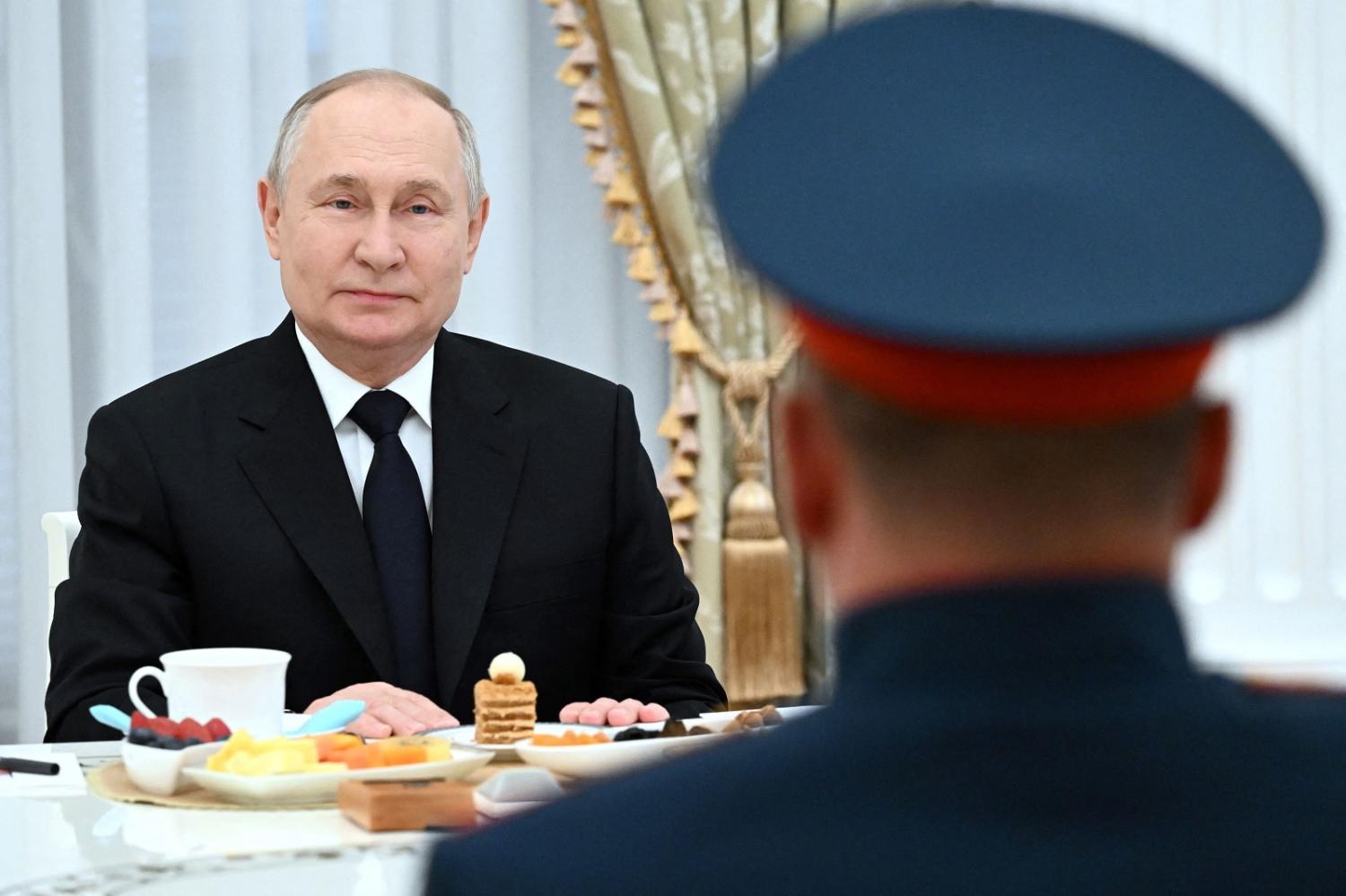 A photo distributed by Russian agency Sputnik shows President Vladimir Putin meeting servicemen taking part in the country's "special military operation", 29 September 2023 (Pavel Bednyakov/Pool/AFP via Getty Images)