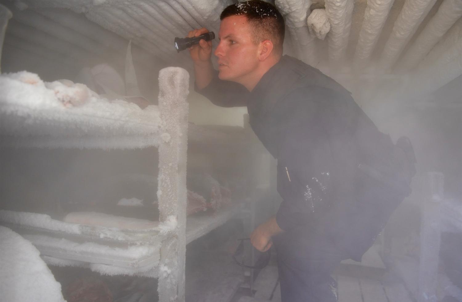 Australian and US officials inspect the freezer of a Taiwanese flagged vessel (Photo: US Coast Guard/Flickr)
