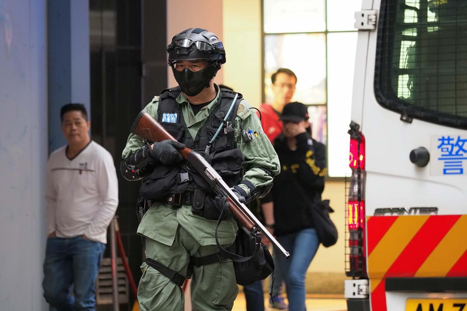 A riot police officer observes the New Year’s Day protest in Hong Kong, 1 January 2020 (Photo: Etan Liam/Flickr)