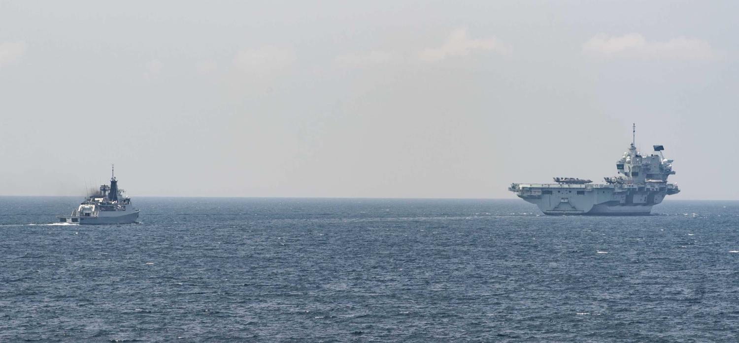 The Royal Navy aircraft carrier HMS Queen Elizabeth (right) and the Royal Malaysian Navy guided missile frigate KD Lekiu in the South China Sea in July (US Navy/Flickr)