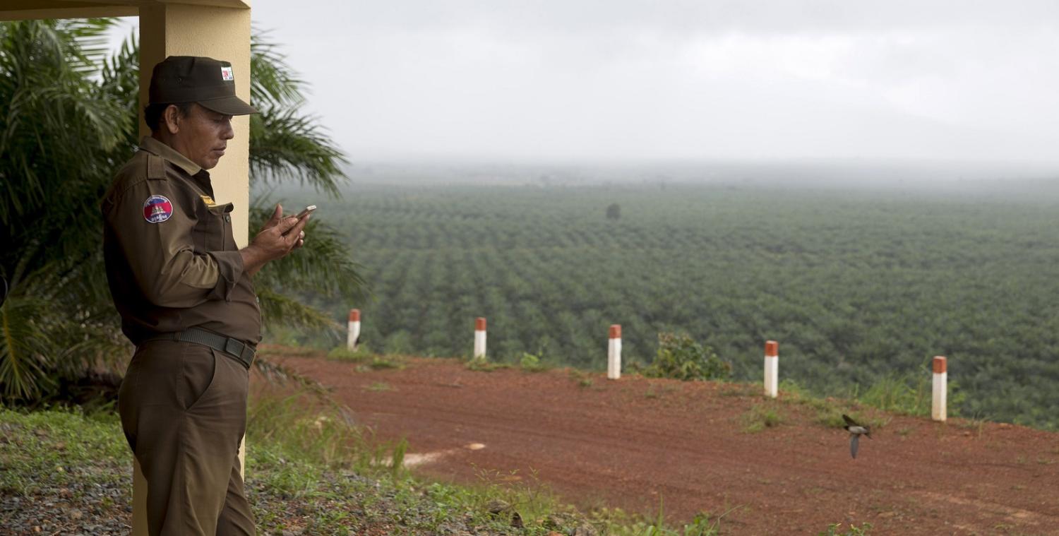 Security guard at a palm oil plantation in Preah Sihanouk province, Cambodia. (Photo: Brent Lewin/Getty Images)