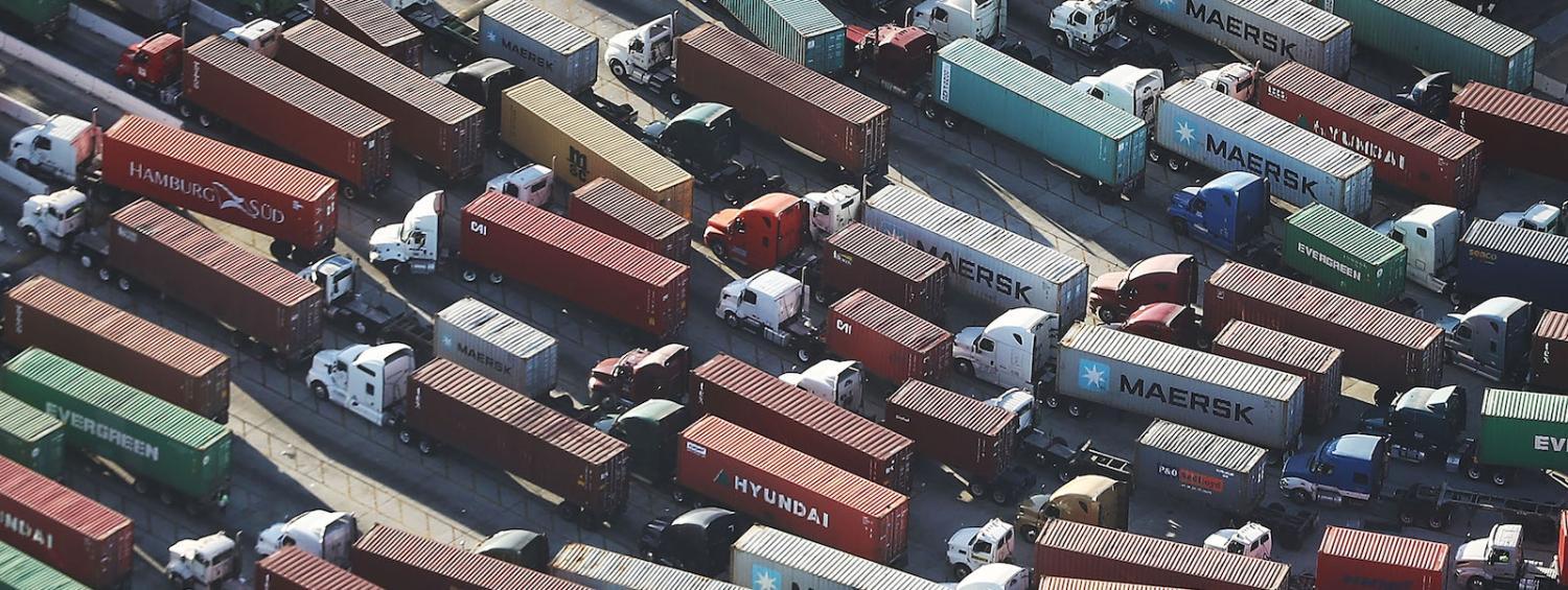 Trucks haul shipping containers at the Port of Los Angeles, California (Photo: Mario Tama via Getty)