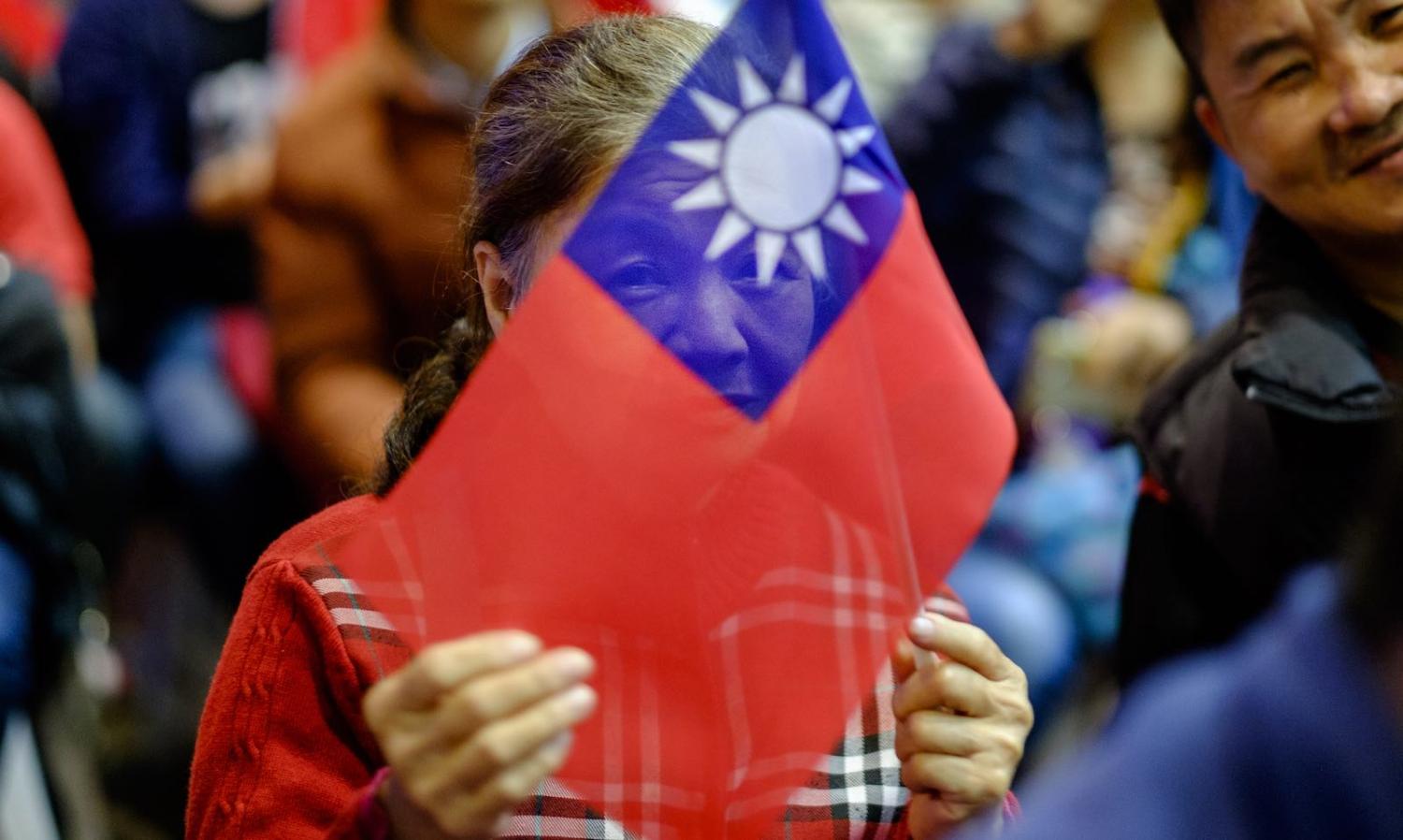 A KMT supporter on election day (Photo: Alberto Buzzola via Getty)