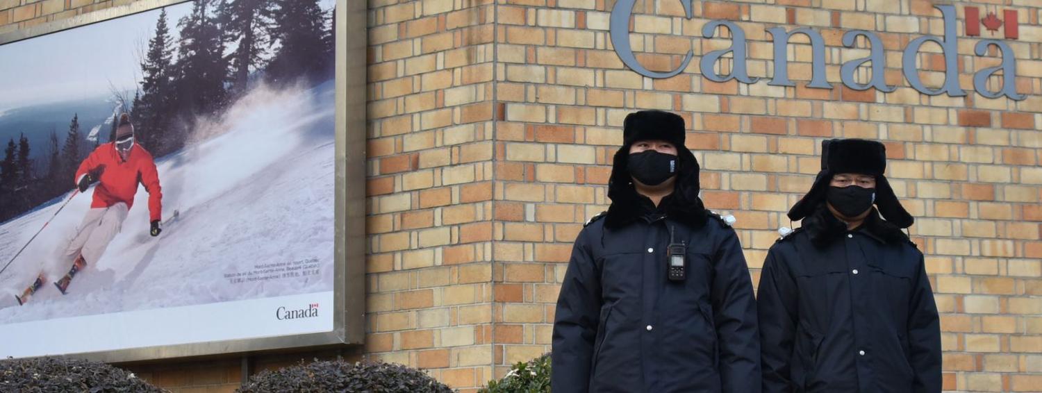 Chinese police officers stand guard outside the Canadian embassy in Beijing (Photo: Greg Baker via Getty)