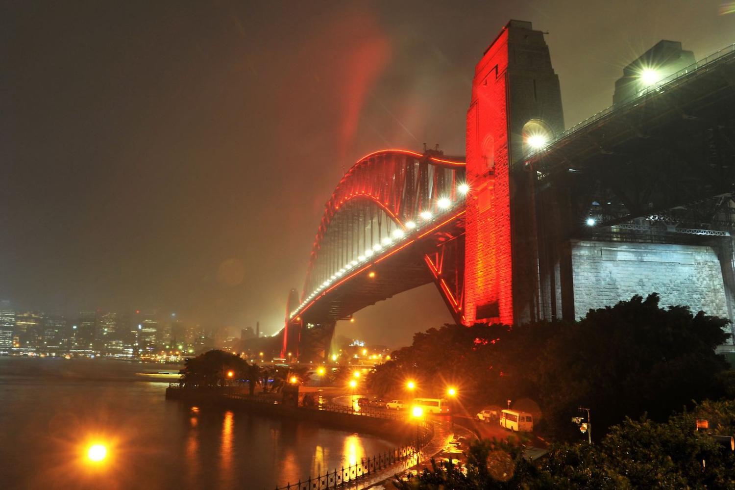 The Sydney Harbour Bridge is lit up in red ahead of the Lunar New Year in Sydney in February (Photo: Farooq Khan via Getty)