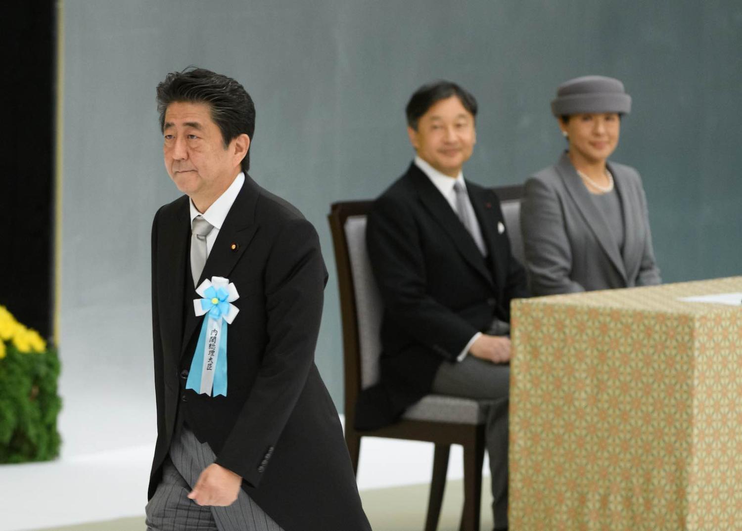 Japanese PM Shinzo Abe walks past Emperor Naruhito and Empress Masako during a service to mark the 74th anniversary of the end of the Second World War, Tokyo, 15 August 2019 (Photo: Akio Kon via Getty)
