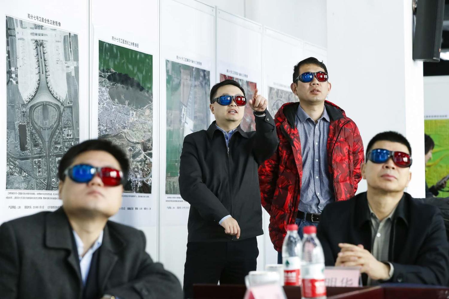 Watching 3-D images during the launching ceremony of the Gaofen-7 Earth observation satellite in Beijing, 10 December 2019 (Shen Bohan/Xinhua via Getty Images)