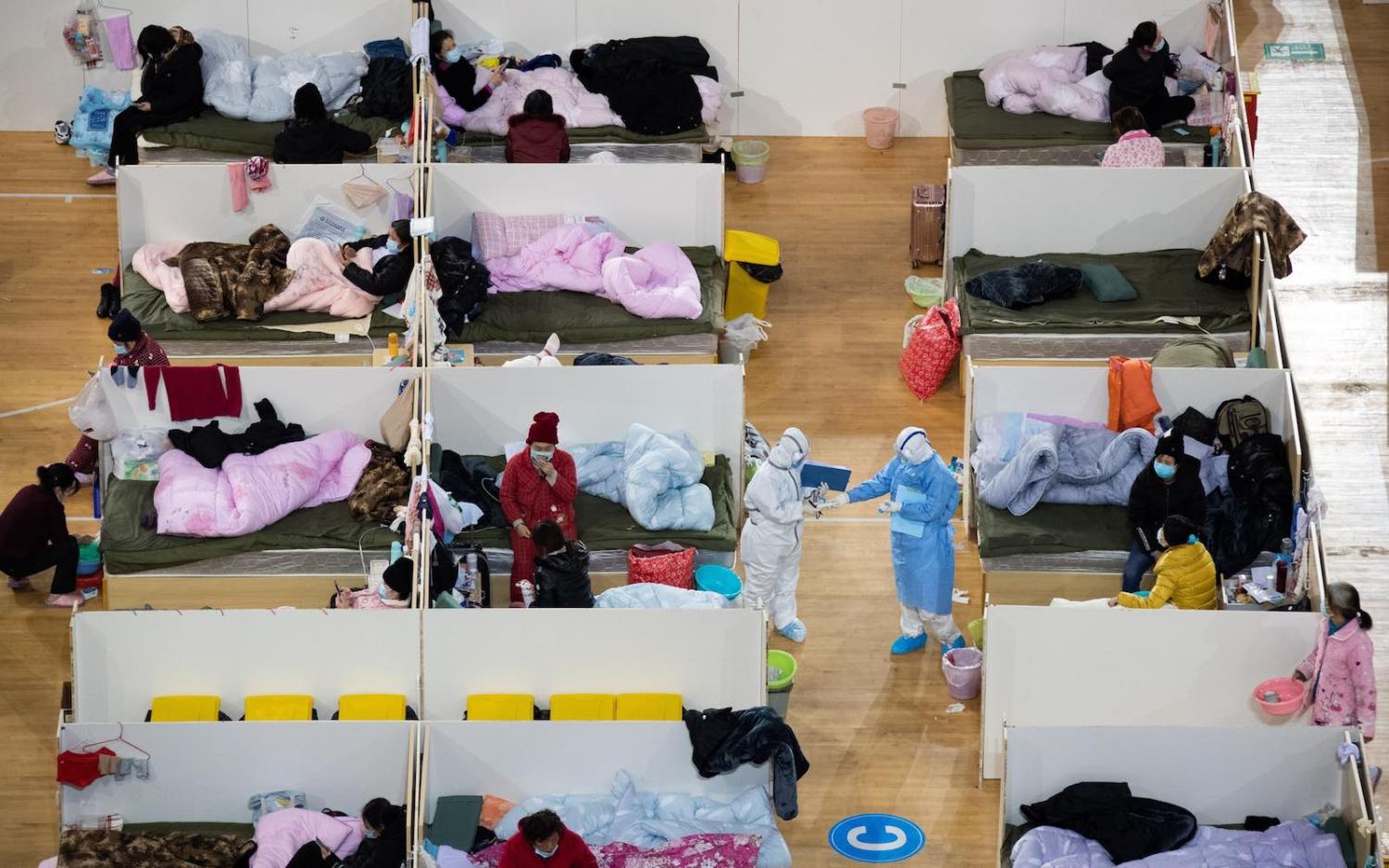Patients with mild symptoms of the COVID-19 coronavirus in a temporary hospital at a sports stadium in Wuhan, China (STR via Getty Images)