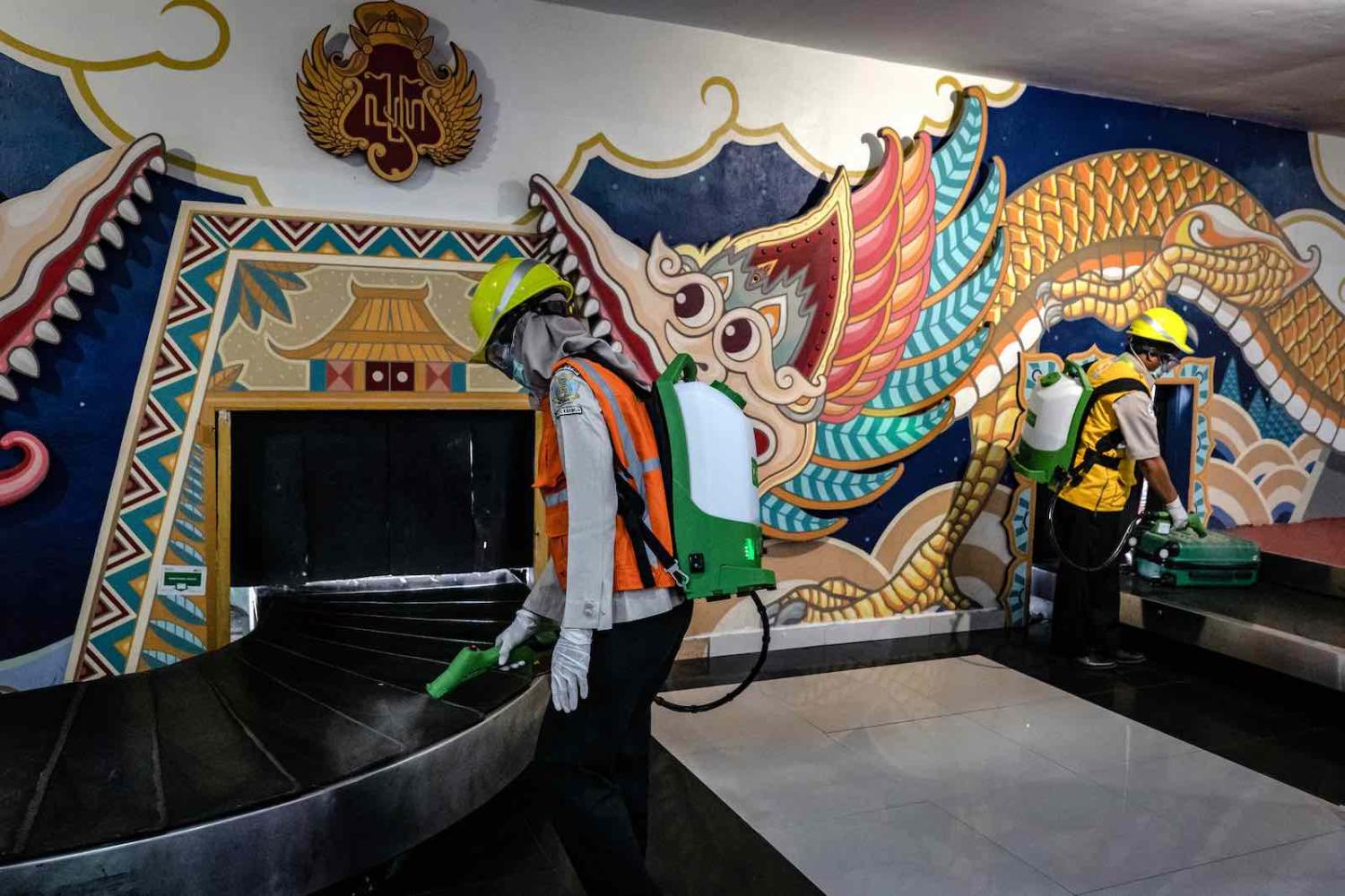 Indonesian medical officers spray disinfectant at Adisucipto International Airport on 16 March in Yogyakarta (Ulet Ifansasti/Getty Images)