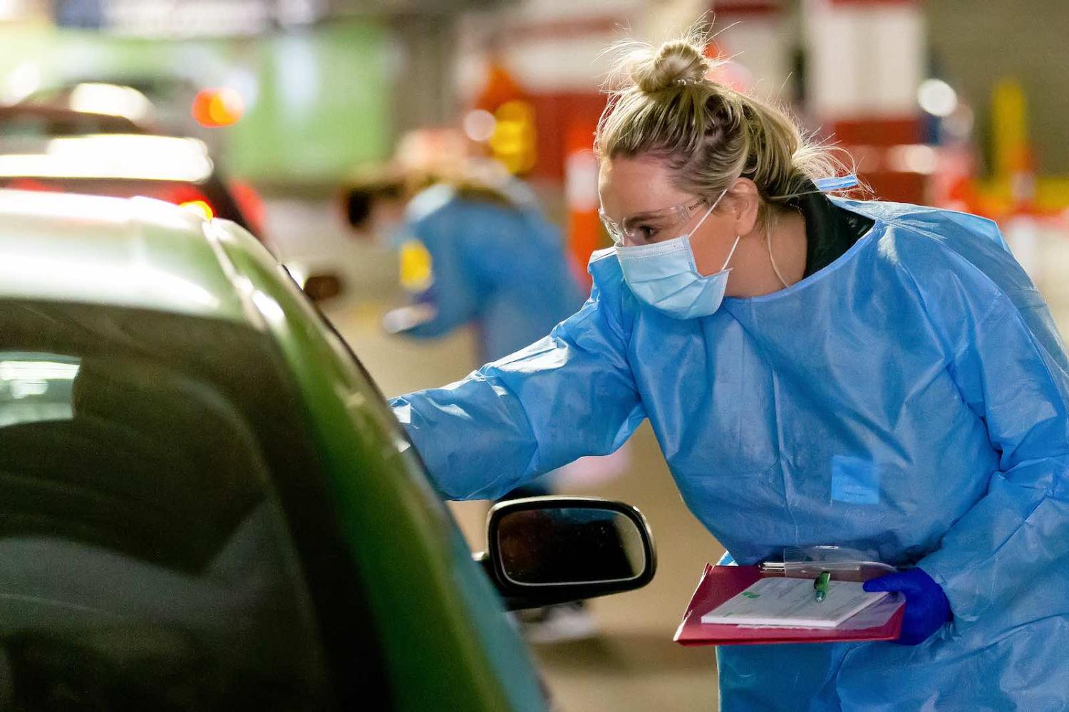 A nurse takes swabs at a mobile testing site for Covid-19, Melbourne, 30 April (Speed Media/Icon Sportswire via Getty)