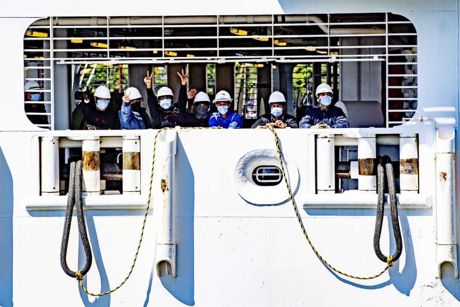 Crew members of a ship docked in Rotterdam (Robin Utrecht via Getty Images)