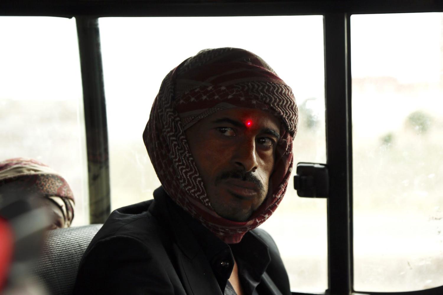 A man on a bus in Sana’a, Yemen has his temperature checked, 25 May (Mohammed Hamoud/Getty Images)