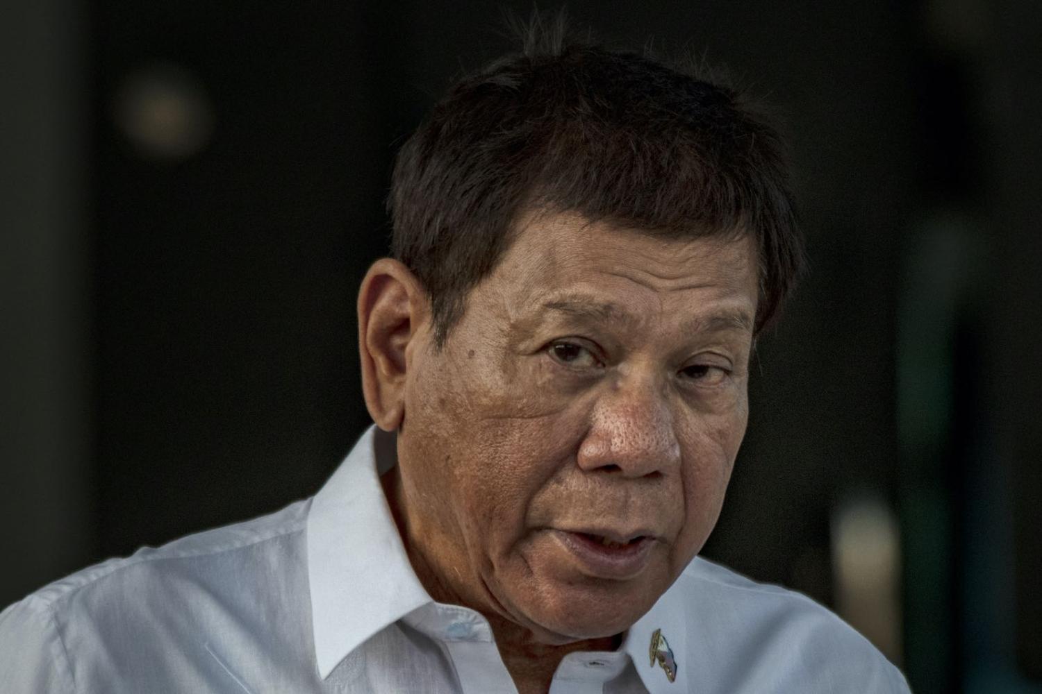 Philippine President Rodrigo Duterte watches the arrival of a shipment of Sinovac Biotech Covid-19 vaccines on 28 February 2021 in Manila (Ezra Acayan/Getty Images)