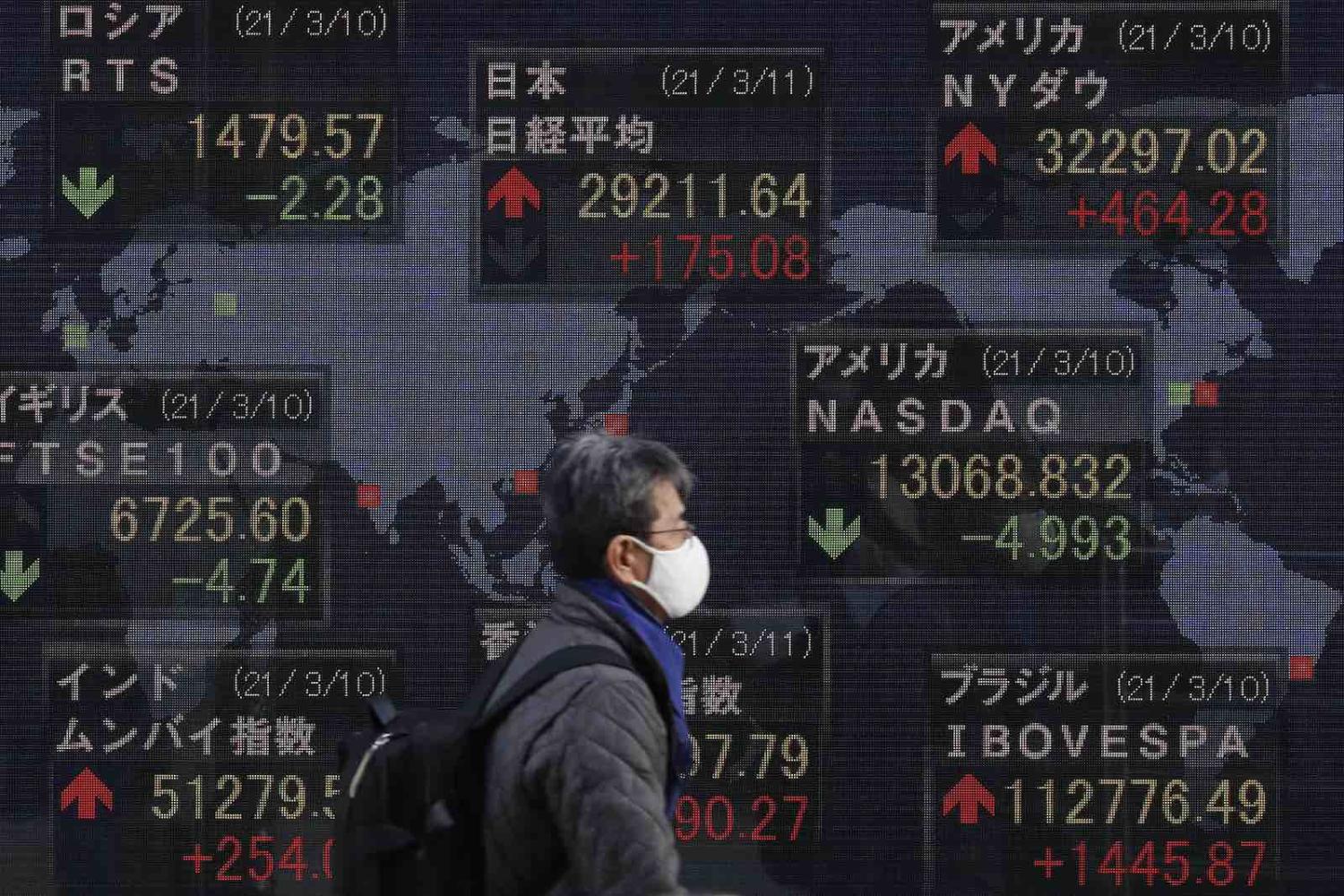 Global stock exchange updates on display in Tokyo, 11 March 2021 (James Matsumoto/SOPA Images/LightRocket via Getty Images)