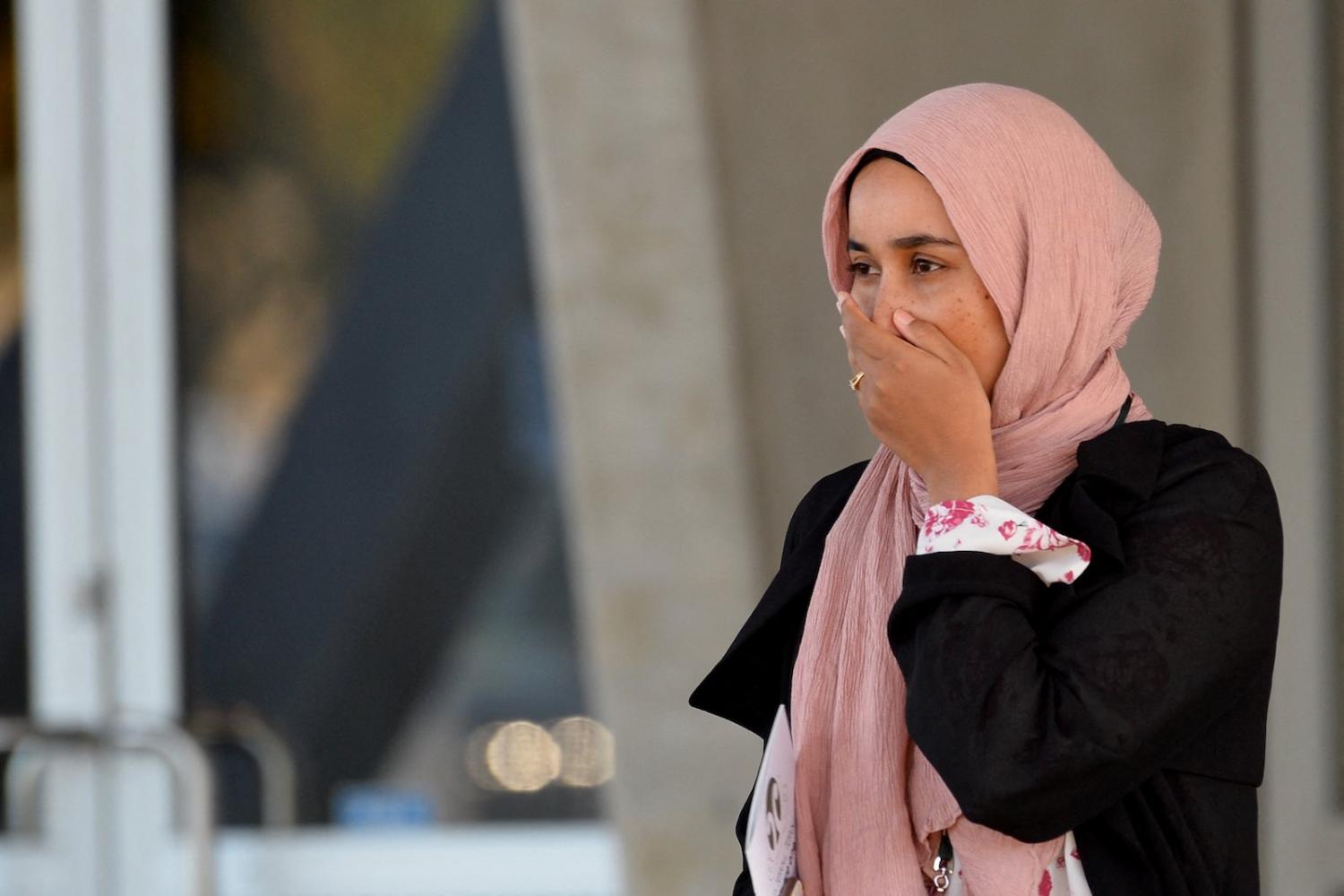 A woman leaves a national service in remembrance of the mosque attacks in Christchurch, New Zealand, 13 March (Sanka Vidanagama/AFP via Getty Images)