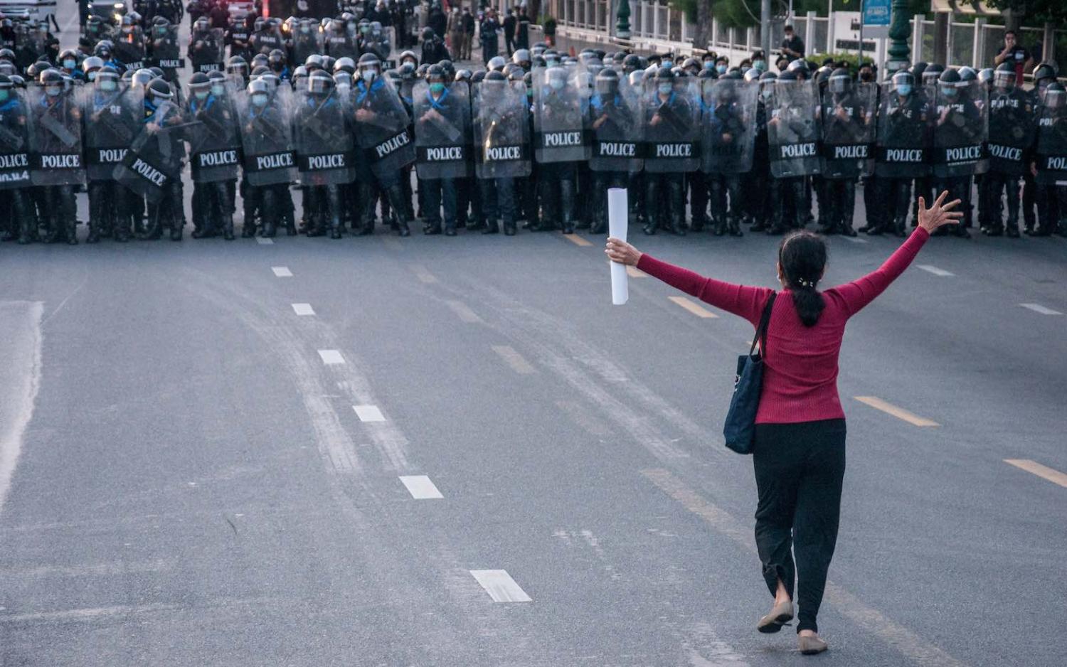A protester pleads with police to allow a demonstration outside Government House in Bangkok, 28 March 2021 (Peerapon Boonyakiat/SOPA Images/LightRocket via Getty Images)
