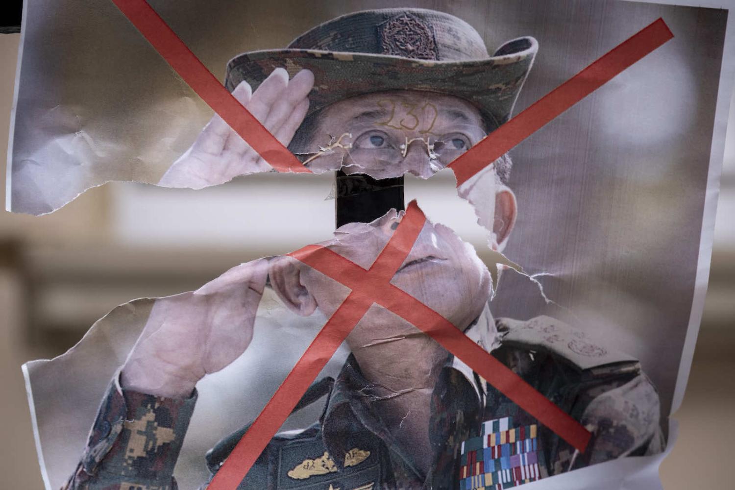 Protesters in London last year with an image Myanmar's military leader Senior General Min Aung Hlaing in a demonstration against the coup (Richard Baker via Getty Images)