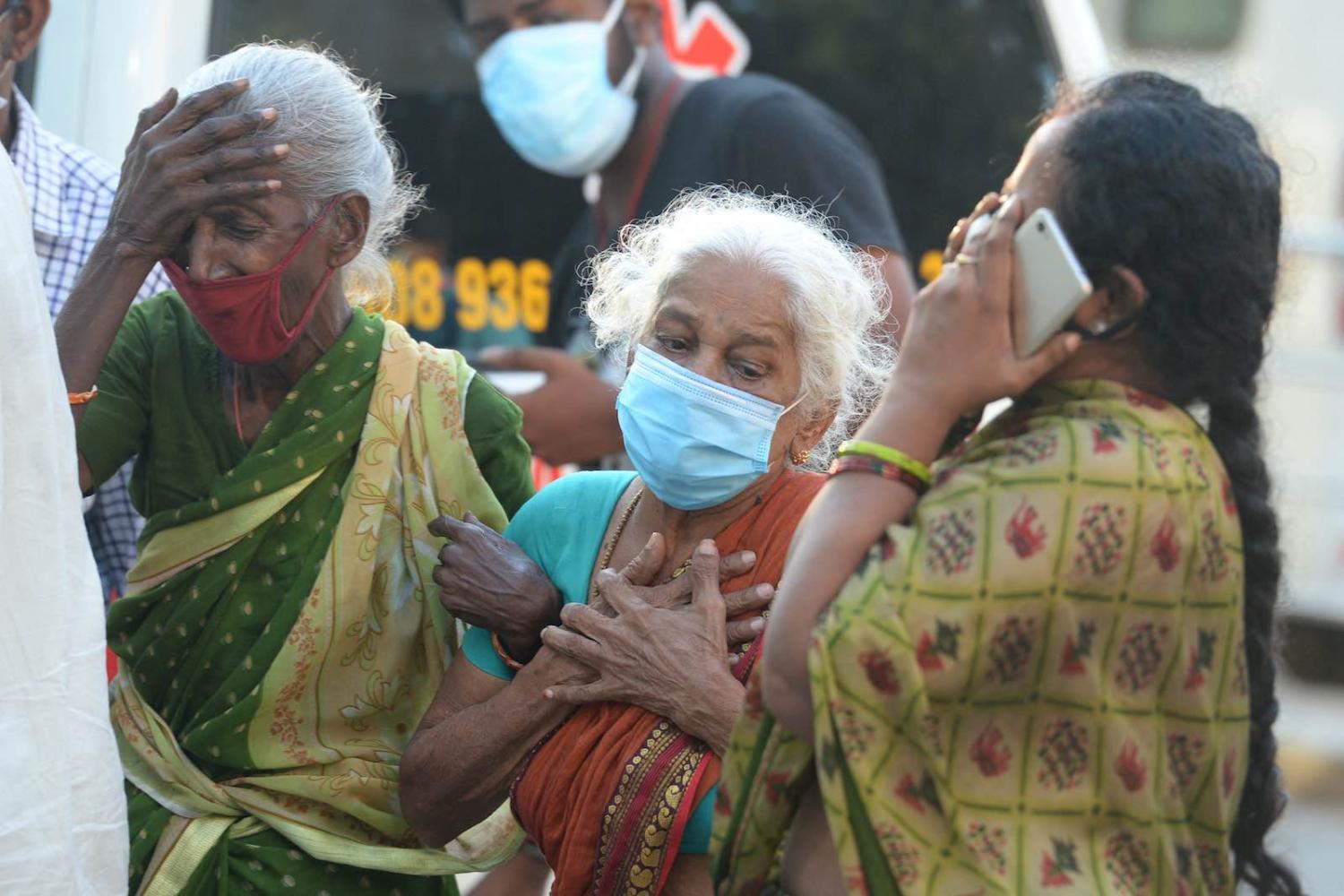 Relatives mourn a loved one who died of Covid-19, outside a mortuary in Chennai, Tamil Nadu state, 5 May 2021 (Arun Sankar/AFP via Getty Images)