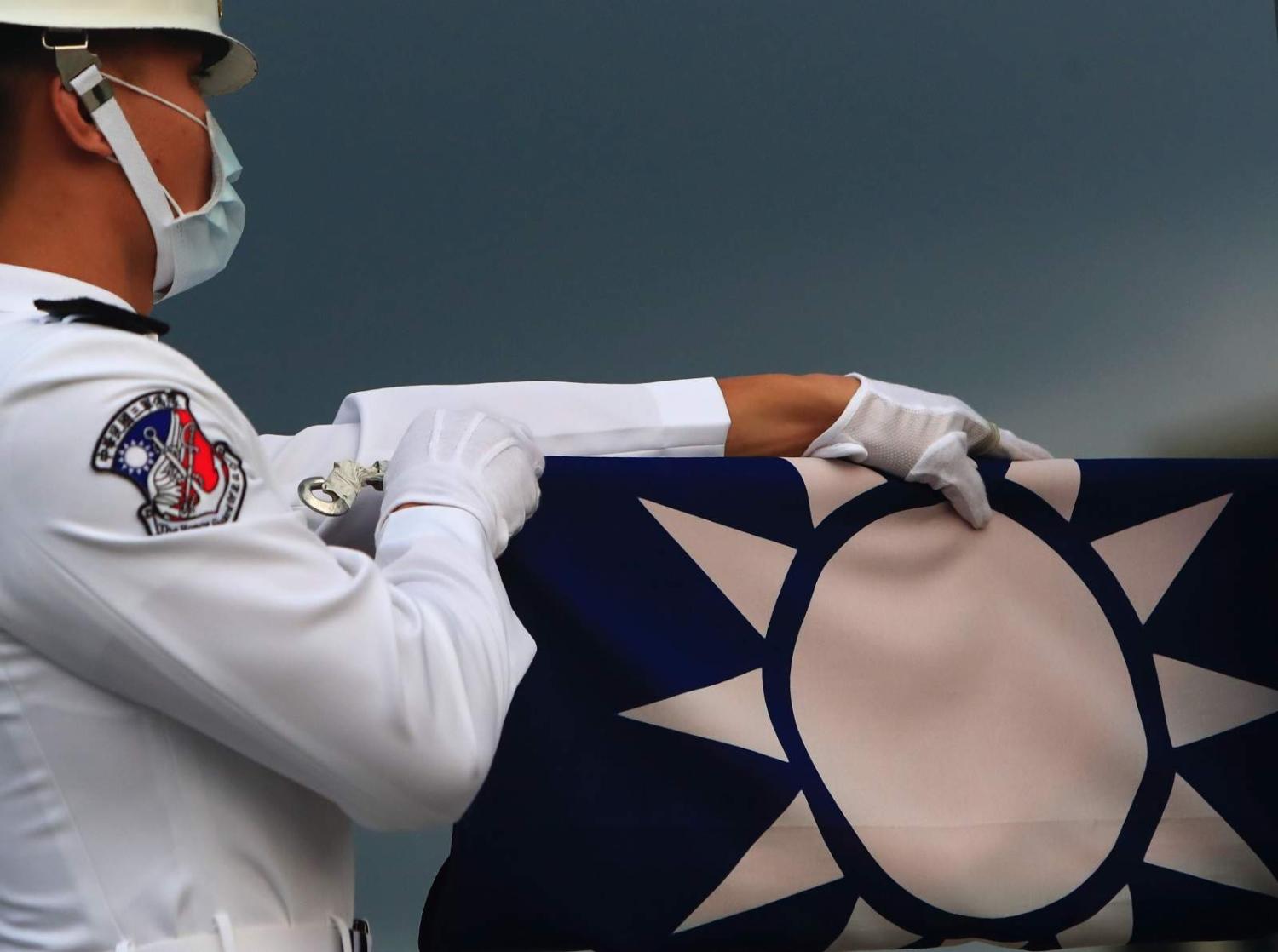 Taiwanese honour guards hold a Taiwan flag at Liberty Square amid a surge of domestic COVID-19 cases and rising Taiwan-China tensions, Taipei, 23 May 2021 (Ceng Shou Yi/NurPhoto via Getty Images)
