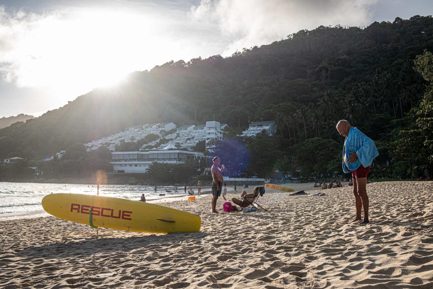 Locals and some of the first tourist to arrive in Phuket enjoy the beach in Nai Harn on 4 July (Thomas De Cian/NurPhoto via Getty Images)