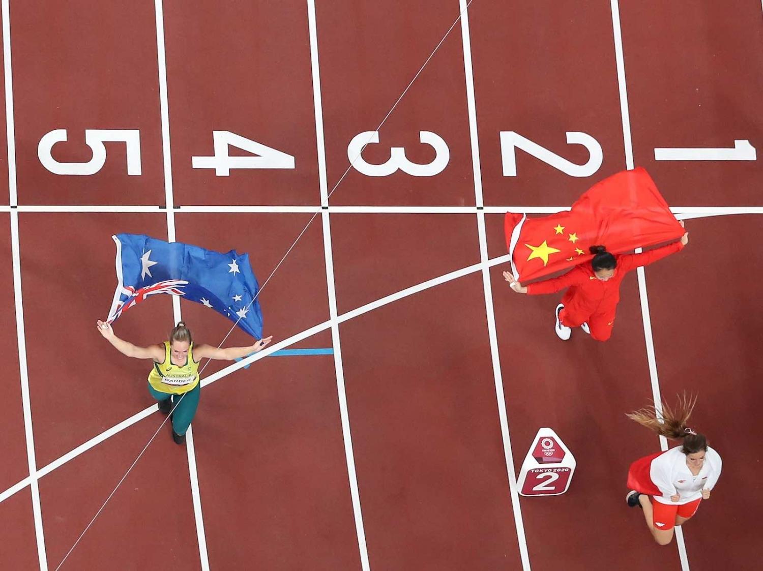 Kelsey-Lee Barber of Australia and Liu Shiying of China celebrate after the women’s javelin throw final at the Tokyo 2020 Olympic Games, 6 August (Lui Siu Wai/Xinhua via Getty Images)