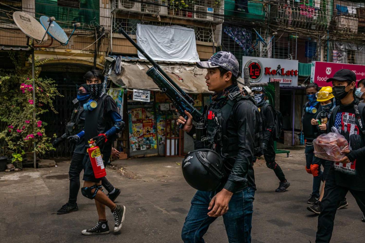 Anti-coup protesters carry improvised weapons during a protest on 3 April 2021 in Yangon, Myanmar (Stringer/Getty Images)