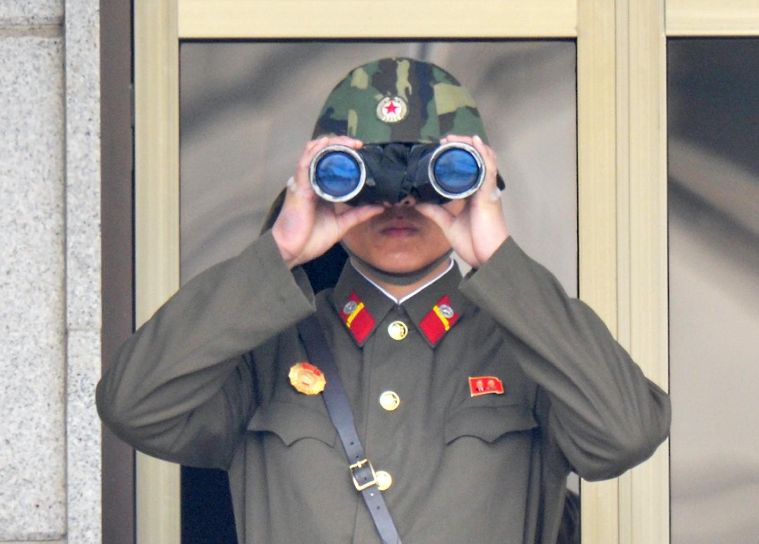 A North Korean soldier watches from his quarters at the truce village of Panmunjom in the demilitarised zone, April 2013 (Kim Jae-Hwan/AFP via Getty Images)