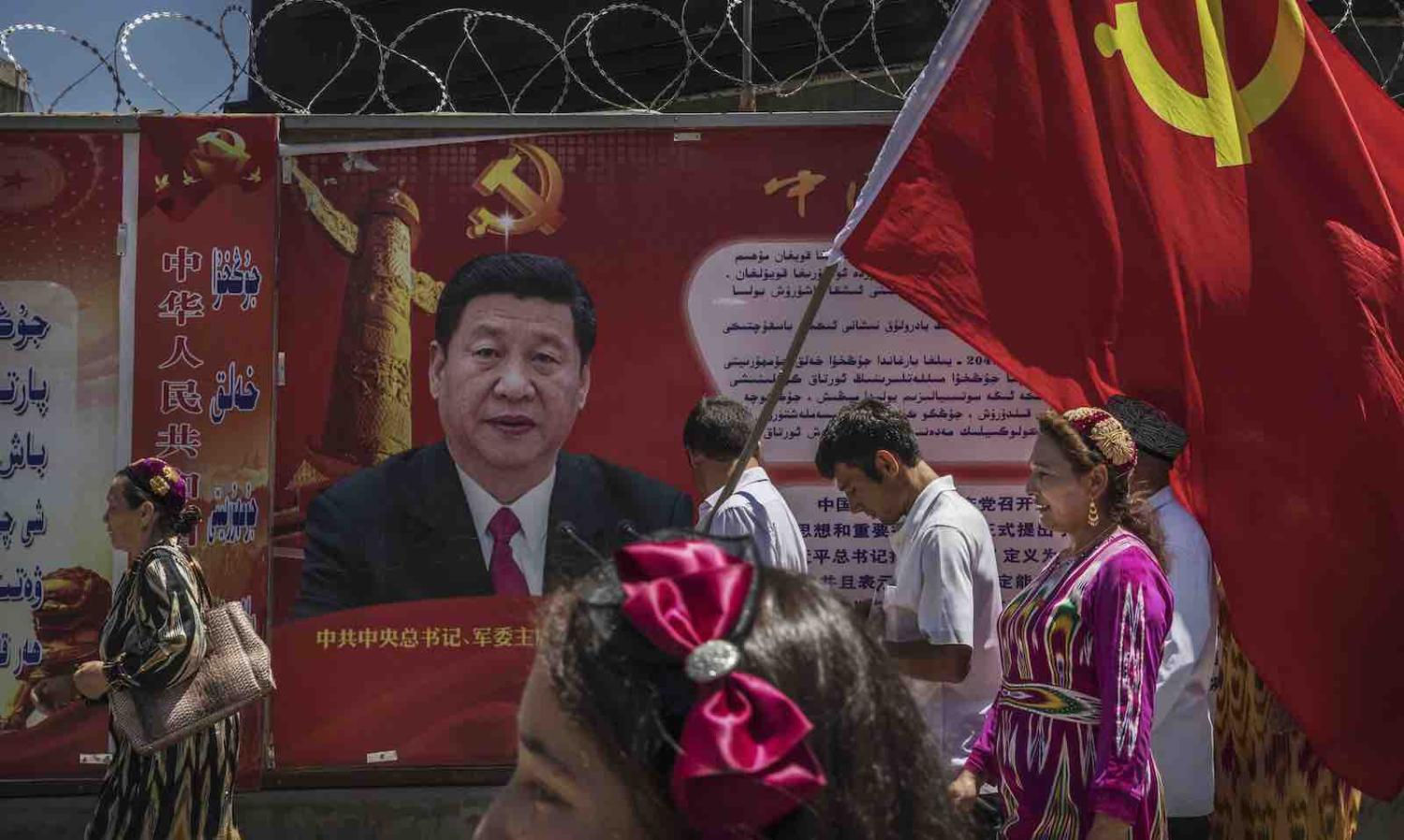 Ethnic Uyghur members of the Chinese Communist Party in Kashgar, Xinjiang (Photo: Kevin Frayer/Getty)