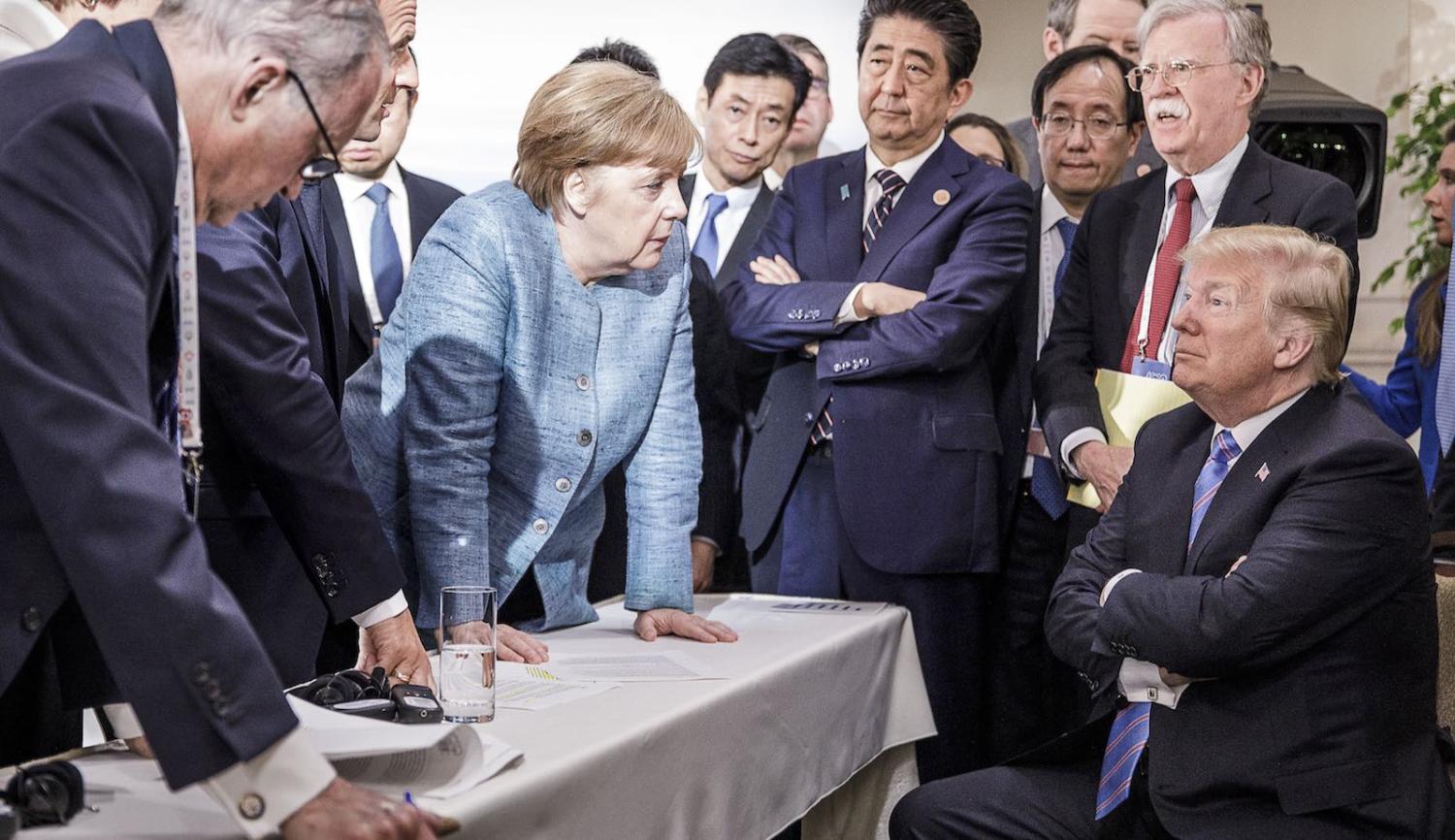 German Chancellor Angela Merkel deliberates with US President Donald Trump on 9 June at La Malbaie, Canada (Photo: Jesco Denzel via Getty)