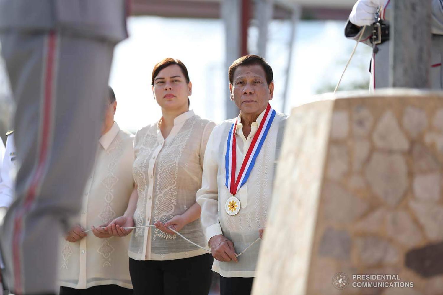 President Rodrigo Duterte leads a flag-raising ceremony with his daughter, Davao City Mayor Sara Duterte-Carpio, in Davao City, 30 December 2019 (Karl Norman Alonzo/Presidential Communications Operations Office)