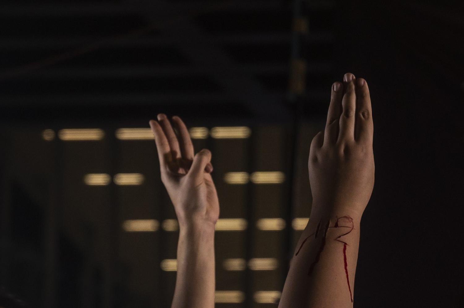 The number 112 carved into the arm of Panusaya “Rung” Sithijirawattanaku at anti-lèse majesté law (Section 112) protests in Bangkok, 31 October (Sirachai Arunrugstichai/Getty Images)