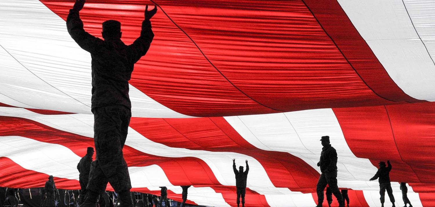 US Airmen hold up an American flag in Nevada, December 2016 (Photo: US Dept of Defense)